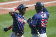 Minnesota Twins' Eddie Rosario, left, is greeted by Miguel Sano (22) after hitting a solo home run in the fifth inning of a baseball game against the Pittsburgh Pirates, Thursday, Aug. 6, 2020, in Pittsburgh. (AP Photo/Keith Srakocic)