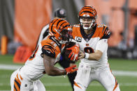 Cincinnati Bengals quarterback Joe Burrow, right, hands the ball off to running back Joe Mixon during the first half of the team's NFL football game against the Cleveland Browns, Thursday, Sept. 17, 2020, in Cleveland. (AP Photo/Ron Schwane)