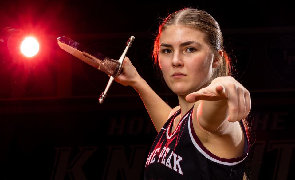 Lone Peak’s Kailey Woolston poses with a sword