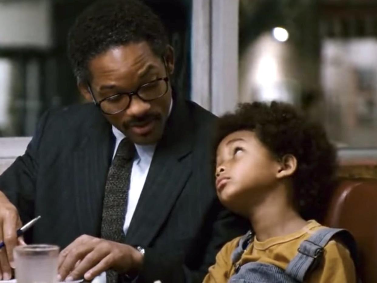 Will Smith and Jaden Smith sitting next to each other at a table in "The Pursuit of Happyness."