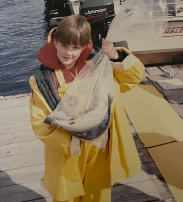 Randy is seen fishing as a child. 