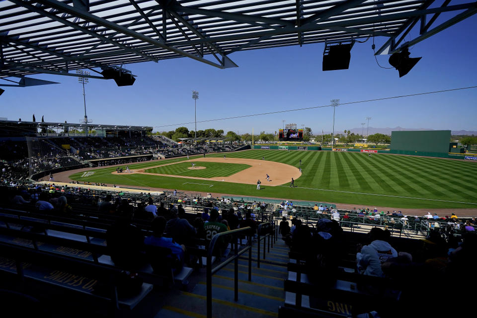 The Oakland Athletics and the Milwaukee Brewers compete during the third inning of a spring training baseball game, Wednesday, March 10, 2021, in Mesa, Ariz. (AP Photo/Matt York)