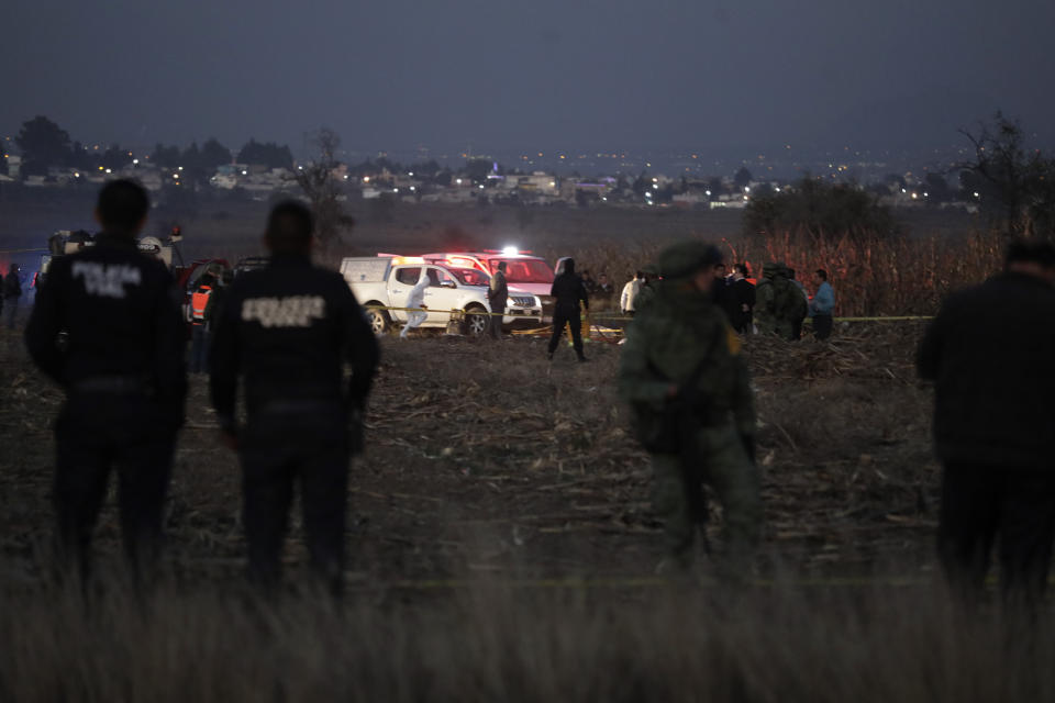 Emergency rescue personnel, the army and the police arrive to the scene of a helicopter crash where Puebla Gov. Martha Erika Alonso and her husband Rafael Moreno Valle, a former Puebla governor, died near Puebla City, southeast of Mexico City on Monday, Dec. 24, 2018. The husband-and-wife political power couple died Christmas Eve in the crash, Mexican officials reported. (AP Photo/Pablo Spencer)