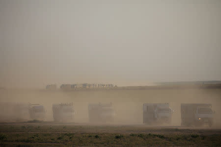 Trucks loaded with civilians ride near the village of Baghouz, Deir Al Zor province, Syria February 25, 2019. REUTERS/Rodi Said