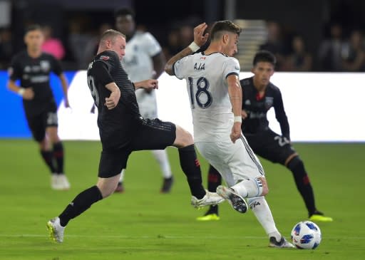 Wayne Rooney (L) of DC United said he likes how football is growing in America and says it might one day rival such leagues as the NFL and NBA