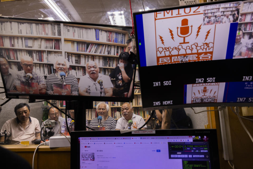 "The Bull" Tsang Kin-shing, right, founder of Hong Kong's pro-democracy Citizens' Radio station, along with guests, hold their last broadcast in Hong Kong, Friday, June 30, 2023. (AP Photo/Louise Delmotte)
