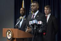 United States Attorney Markenzy Lapointe speaks to the media about a network of nursing school operators, centered in South Florida, who allowed students to buy diplomas without the proper training as representatives from FBI Miami and Department of Health and Human Services Office of Inspector General (HHS-OIG), Miami Regional Office stand behind him during a press conference at the U.S. Attorney's Office for the Southern District of Florida in Downtown Miami on Wednesday, Jan. 25, 2023. (D.A. Varela/Miami Herald via AP)