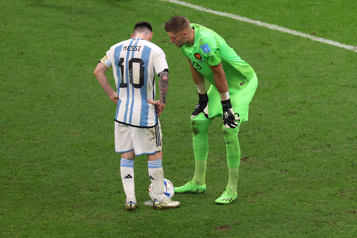 Argentina's Lionel Messi talks with Netherlands goalkeeper Andries Noppert before attempting a penalty during a World Cup quarterfinal at Lusail Stadium on December 09, 2022 in Lusail City, Qatar. (Photo by Elsa/Getty Images)