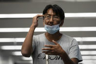 Yuki Kitazumi, a Japanese freelance journalist detained by security forces in Myanmar in mid-April and accused of spreading fake news criticizing the military coup, gestures to speak to the media as he arrives at Narita International Airport, in Narita, east of Tokyo. (AP Photo/Eugene Hoshiko)