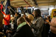 Migrants cheer after receiving the news that Malta would allow them to disembark after weeks stranded at sea