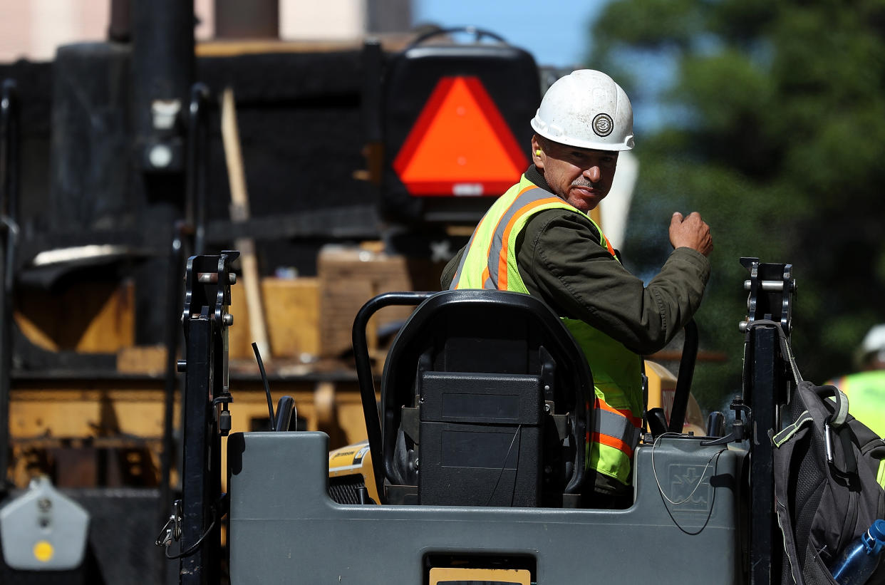 A construction worker operates a steam roller while paving a road on October 5, 2018 in San Francisco, California. (Photo: Justin Sullivan/Getty Images)