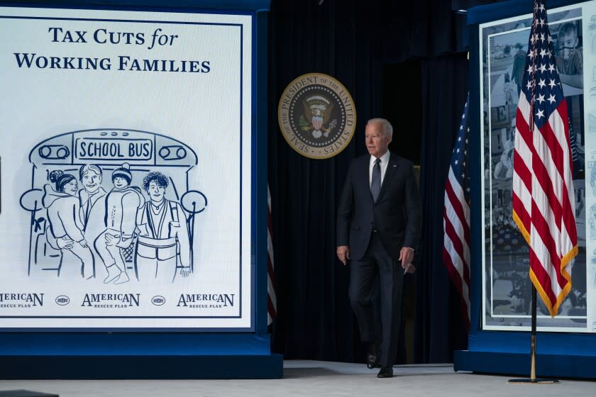 FILE - President Joe Biden arrives to speak at an event to mark the start of monthly Child Tax Credit relief payments, in the South Court Auditorium on the White House complex, on July 15, 2021, in Washington. President Joe Biden and leading Democratic lawmakers have been fighting to make permanent a child tax credit that would give families at least $300 a month per child. But the latest budget deal would extend the payments through the end of the next year.(AP Photo/Evan Vucci, File)