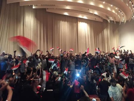 Followers of Iraq's Shi'ite cleric Moqtada al-Sadr are seen in the parliament building as they storm Baghdad's Green Zone after lawmakers failed to convene for a vote on overhauling the government, in Iraq April 30, 2016. REUTERS/Ahmed Saad