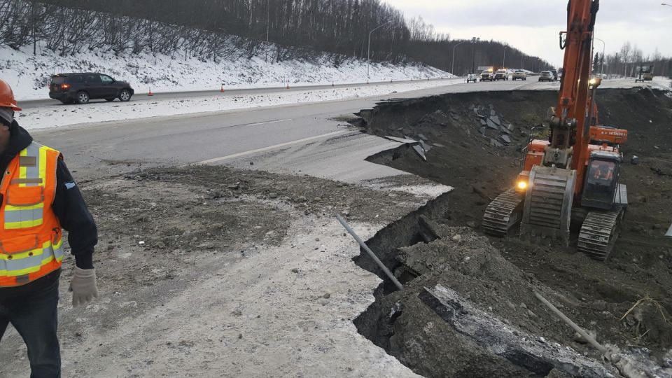 This photo provided by Chris Riekena shows excavation work being conducted Saturday, Dec. 1, 2018, near the Mirror Lake exit of the Glenn Highway near Eklutna, Alaska, to make the highway ready for repaving. The highway was heavily damaged in several spots following a magnitude 7.0 earthquake on Nov. 30, 2018. (Chris Riekena via AP)