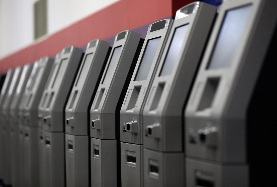 FILE - In this Aug. 30, 2017, photo, automated teller machines are lined up during the manufacturing process at Diebold Nixdorf in Greensboro, N.C. It’s important to find a bank that meets all your unique needs in terms of access, technology and cost. Be sure to consider credit unions or online banks that typically offer lower fees and better interest rates. (AP Photo/Gerry Broome, File)