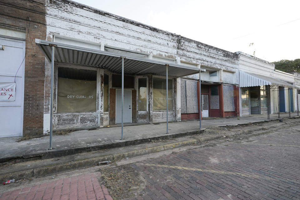 Vacant, unkept, boarded up and weather worn store fronts line a street in downtown Itta Bena, Miss., Thursday, Oct. 22, 2020. Area residents believe the high price of electricity provided by the city as one of the reasons for store closures. (AP Photo/Rogelio V. Solis)