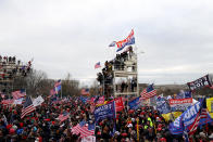 WASHINGTON, DC - JANUARY 06: Protesters stand on scaffolding outside the U.S. Capitol Building on January 06, 2021 in Washington, DC. Pro-Trump protesters entered the U.S. Capitol building after mass demonstrations in the nation's capital during a joint session Congress to ratify President-elect Joe Biden's 306-232 Electoral College win over President Donald Trump. (Photo by Tasos Katopodis/Getty Images)