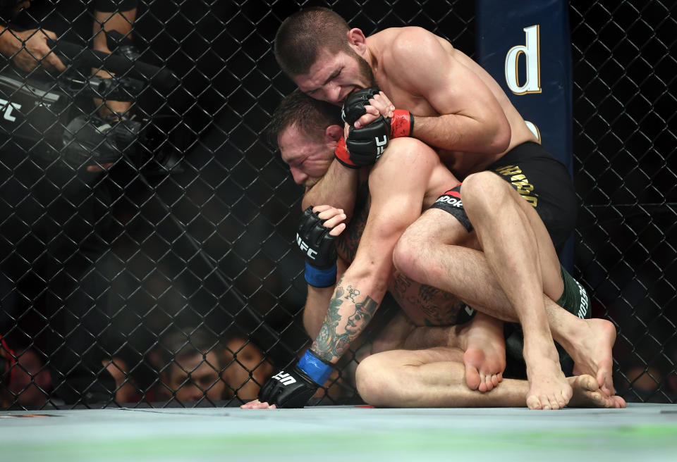 LAS VEGAS, NV - OCTOBER 06:  (R-L) Khabib Nurmagomedov of Russia submits Conor McGregor of Ireland in their UFC lightweight championship bout during the UFC 229 event inside T-Mobile Arena on October 6, 2018 in Las Vegas, Nevada. (Photo by Jeff Bottari/Zuffa LLC/Zuffa LLC via Getty Images)