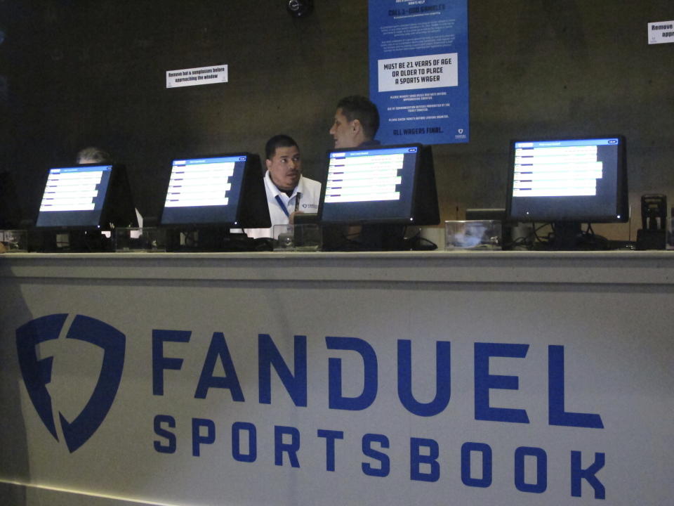 Workers at the FanDuel sports book at the Meadowlands Racetrack in East Rutherford N.J. prepare to take bets moments before it opened on July 14, 2018. On July 8, 2024, New Jersey gambling regulators revealed they had fined FanDuel $2,000 for taking bets in 2022 on mixed martial arts fights that had already happened a week earlier. (AP Photo/Wayne Parry)