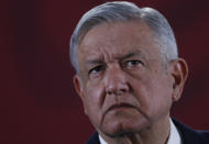 FILE - In this Nov. 29, 2019 file photo, Mexican President Andres Manuel Lopez Obrador listens to questions during his daily morning press conference at the National Palace in Mexico City. Shortly before taking office Lopez Obrador decided to create an army of volunteers dubbed the “servants of the nation,” to canvass people who receive government benefits collecting their personal information in part to see if they might be eligible for yet more help from various programs promised during the campaign for the likes of farmers, the disabled, unemployed youth and the elderly. The effort alarmed opposition political parties who saw it as an attempt to illegally use public funds to promote López Obrador and his leftist Morena party. (AP Photo/Marco Ugarte, File)