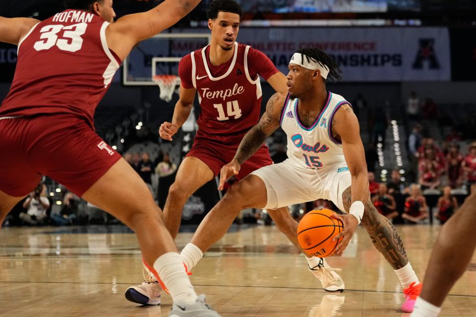 Mar 16, 2024; Fort Worth, TX, USA; Florida Atlantic Owls guard Alijah Martin (15) dribbles between Temple Owls forward Sam Hofman (33) and forward Steve Settle III (14) during the first half at Dickies Arena. Mandatory Credit: Chris Jones-USA TODAY Sports