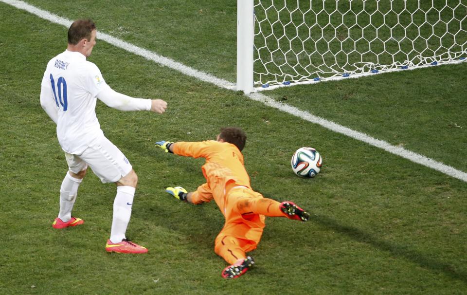 England's Rooney shoots to score a goal past Uruguay's Muslera during their 2014 World Cup Group D soccer match at the Corinthians arena in Sao Paulo