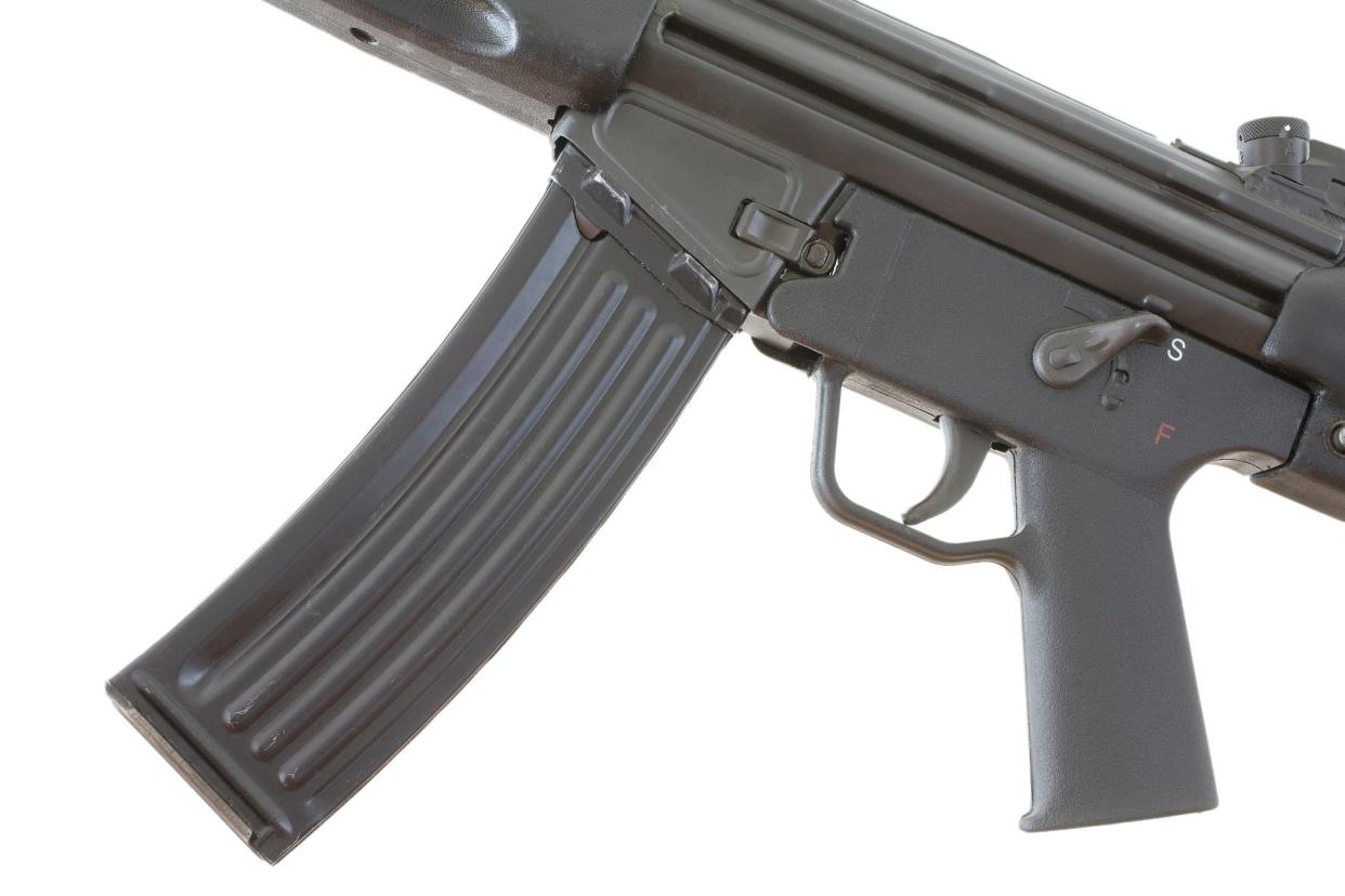 A high-capacity magazine attached to a rifle.