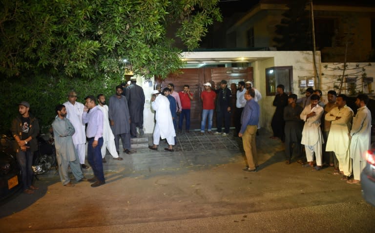 Pakistani people gather outside the house of Junaid Jamshed, a former Pakistani pop star turned evangelical Muslim, in Karachi on December 7, 2016, after his death in plane crash