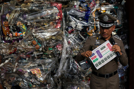 Deputy police chief Pol Gen Wirachai Songmetta stands next to electronic waste hidden in a freight container during a search at Leam Chabang industrial estate, Chonburi province, Thailand, May 29, 2018. REUTERS/Athit Perawongmetha