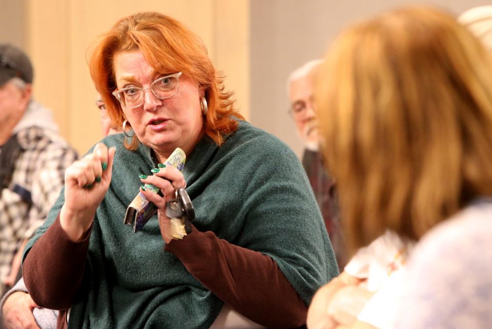 Trish Becker, whose sister is a resident of Portage Manor, speaks to another person Monday, March 6, 2023, at the Save Portage Manor town hall at the St. Joseph County Public Library sponsored by the local chapter of the NAACP.