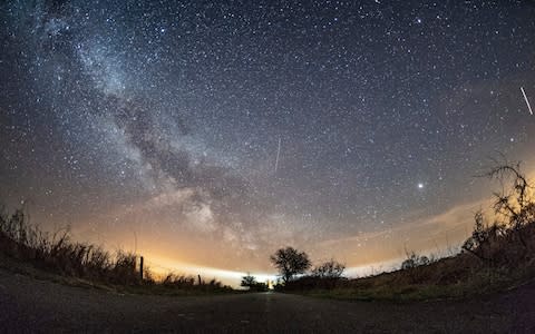 The milky way and traces of Lyrid meteors illuminate the sky over Burg on the Baltic Sea island of Fehmarn, northern Germany - Credit: Daniel Reinhardt/dpa