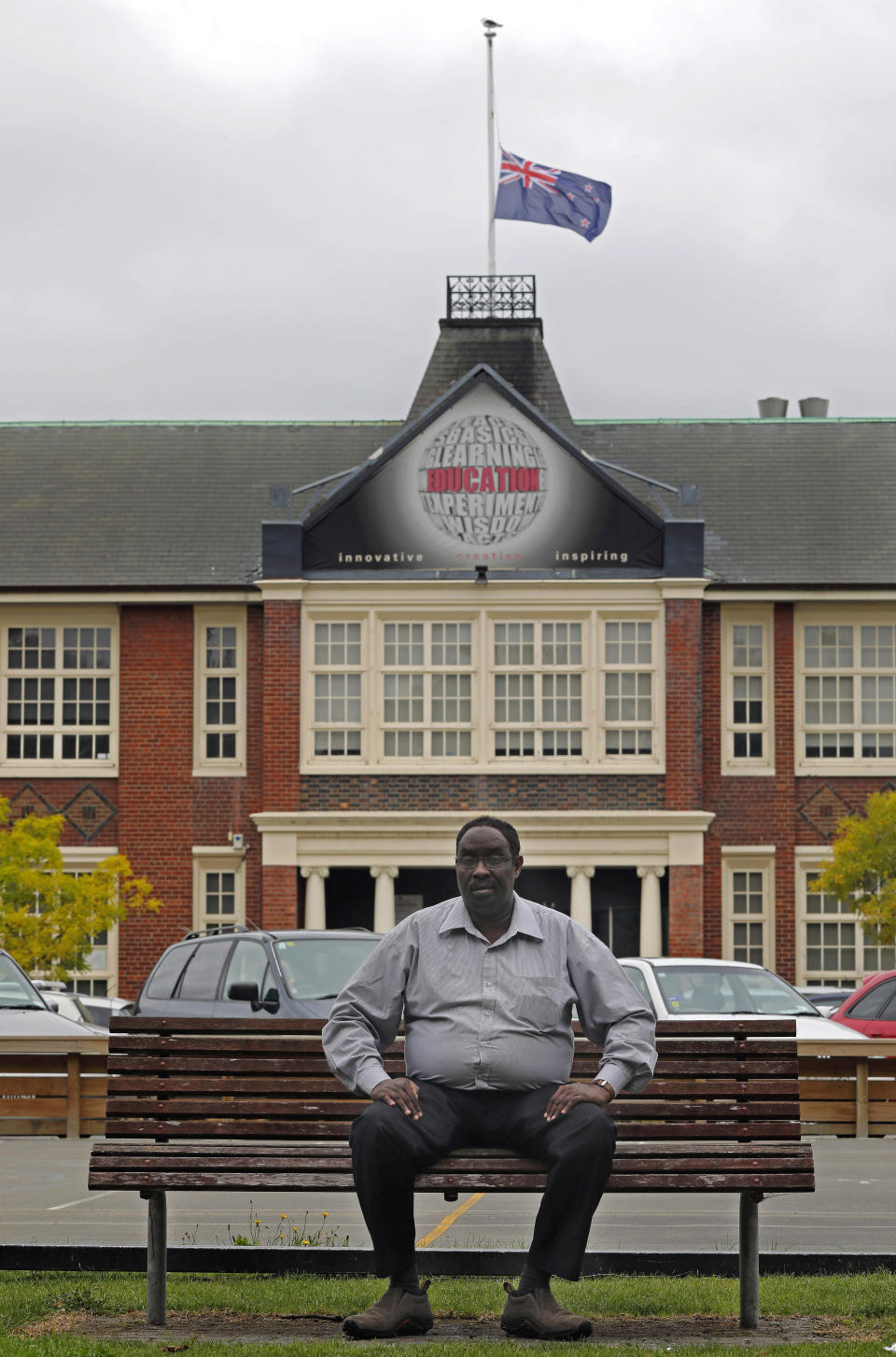 Ahmed Tani poses a portrait in front of Hagley College in Christchurch, New Zealand, Sunday, March 17, 2019. Tani settled in Christchurch after fleeing civil war in Somalia. The New Zealand city seemed a place of peace. It was more than just physically distant from the strife he had known. With its leafy streets, vibrant gardens and green public parks, the Garden City was even visually a world away from his war-scorched past. But that peace hasn't always lasted and now the city will need to use its experience rebuilding from a 2011 earthquake to recover from the nation's worst terrorist attack.(AP Photo/Vincent Yu)
