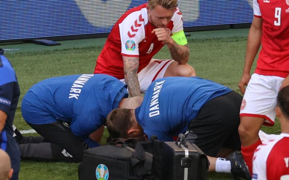 Simon Kjaer watches over team-mate Christian Eriksen - Christian Eriksen collapse: Simon Kjaer and his team-mates’ protective shield was team spirit at its most stirring - GETTY IMAGES