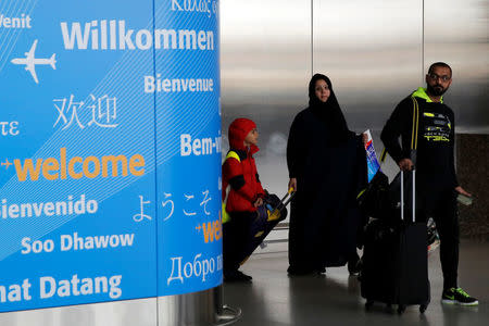 People exit immigration after arriving from Dubai on Emirates Flight 203 at John F. Kennedy International Airport in Queens, New York, U.S., January 28, 2017. REUTERS/Andrew Kelly