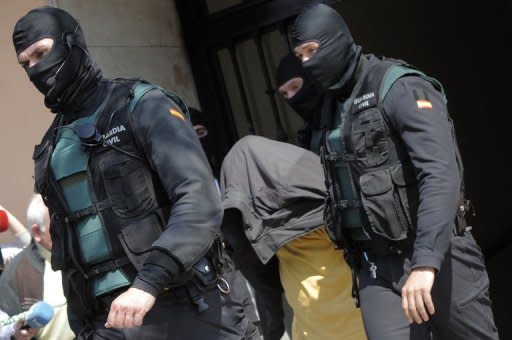 Spanish Civil Guards escort a suspected Al-Qaeda member after his arrest in the eastern Spanish city of Valencia on March 27, 2012. Spanish police arrested three suspected Al-Qaeda members thought to have been planning an attack in Spain or elsewhere in Europe and seized enough explosives to blow up a bus, the government said Thursday