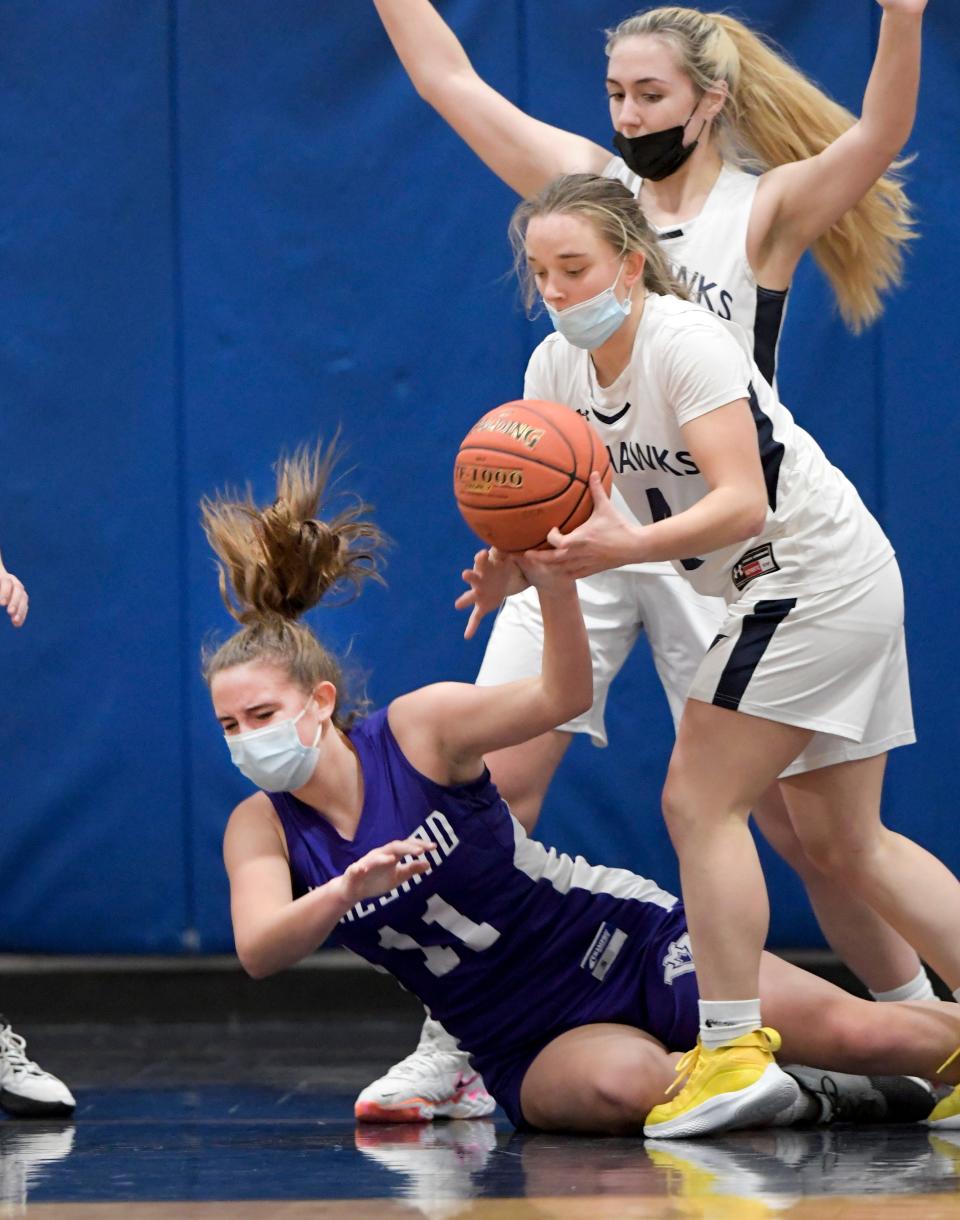 Lily Shanahan of Cape Cod Academy grabs the loose ball as Caroline Jane Walsh of Martha's Vineyard goes to the floor. The Seahawks defeated the Vineyarders 47-45 in double overtime.