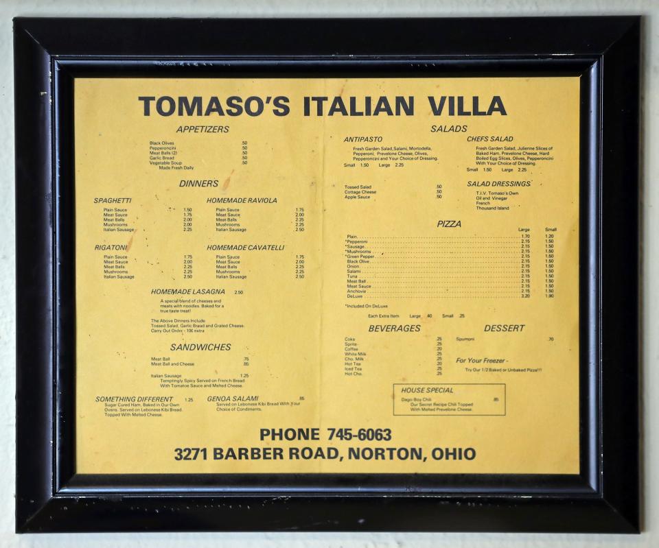 A framed menu shows prices from Tomaso's Italian Villa's1973 opening.