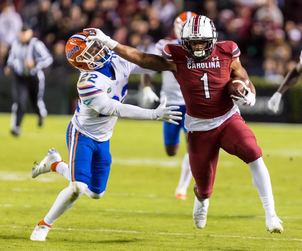 South Carolina running back MarShawn Lloyd stiff-arms Florida safety Rashad Torrence II last Saturday at Williams-Brice Stadium in Columbia, S.C., in 2021.