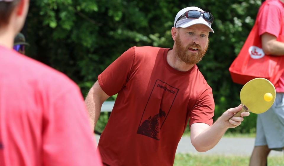 Daniel Lowder takes part in the ping pong tournament during the Goat Island Games held Saturday, May 7, 2022, in Cramerton.