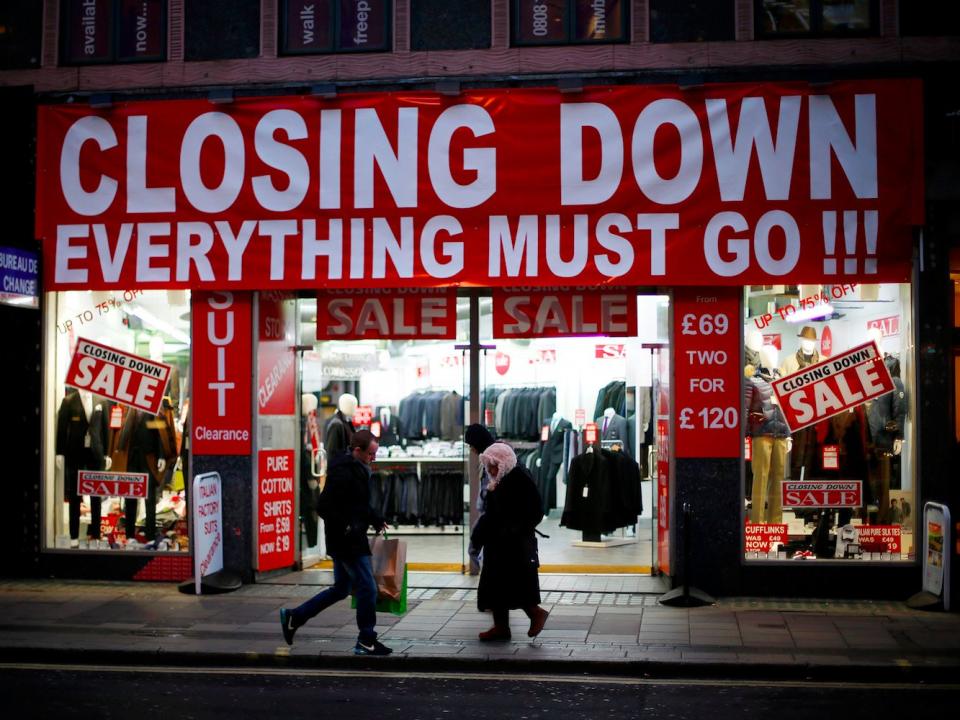 People walk past a business advertising a closing down sale in central London December 5, 2012. British finance minister George Osborne said on Wednesday he would break a key debt promise and warned that growth would be weaker than expected in a bleak outlook that could damage his party's hopes of winning a 2015 election.