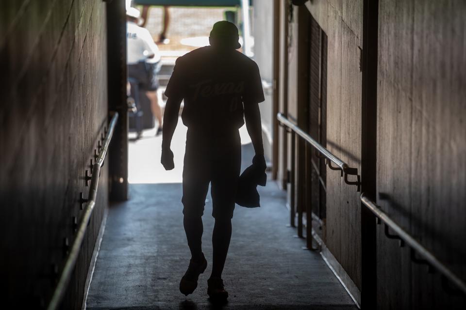 Texas shortstop Trey Faltine walks up the ramp at Charles Schwab Field before Sunday's game against Texas A&M at the College World Series. The Longhorns lost 10-2, ending their season. “The Aggies were better than us today,” UT coach David Pierce said. “It’s been an incredible run, and it’s over.”