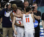 Virginia guard Kyle Guy (5) celebrates with teammates Mamadi Diakite, left, and Ty Jerome, right, after a semifinal round game against Auburn in the Final Four NCAA college basketball tournament, Saturday, April 6, 2019, in Minneapolis. (AP Photo/Matt York)