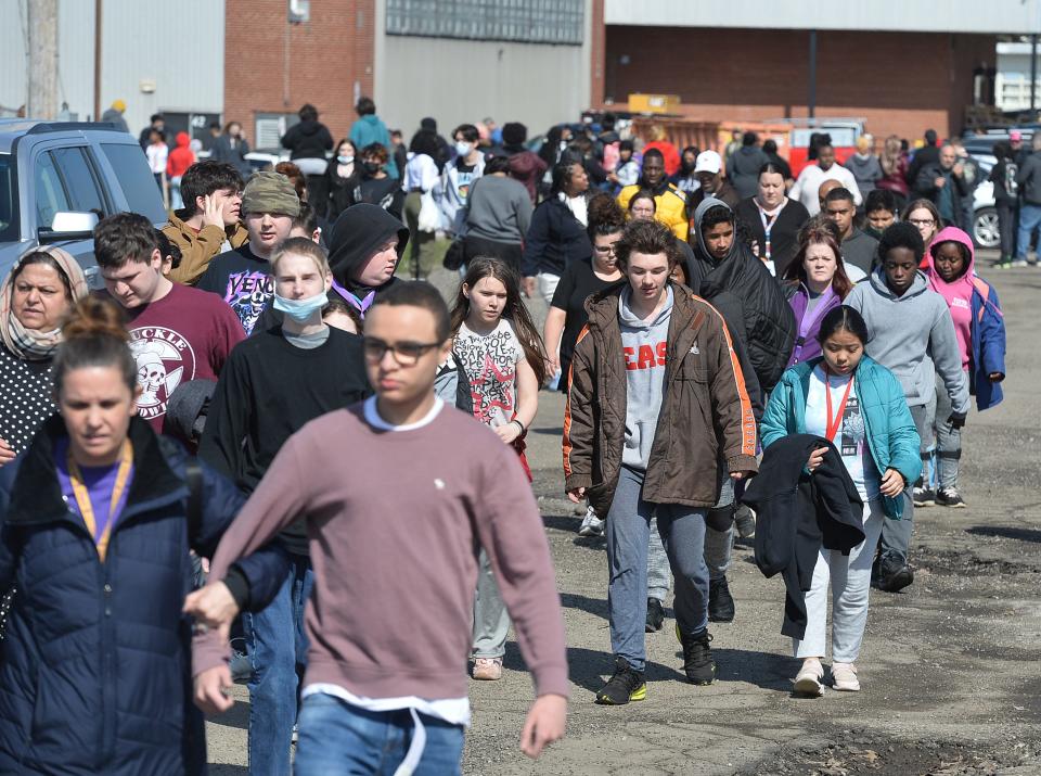 Students and parents leave Erie High School, April 5, 2022, following a shooting that injured one student earlier in the day. 