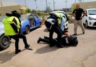 Arab Israeli police recruits detain their colleague during a simulation as part of a training exercise at Israeli police academy center in Beit Shemesh, Israel August 24, 2016. Picture taken August 24, 2016. REUTERS/Ammar Awad