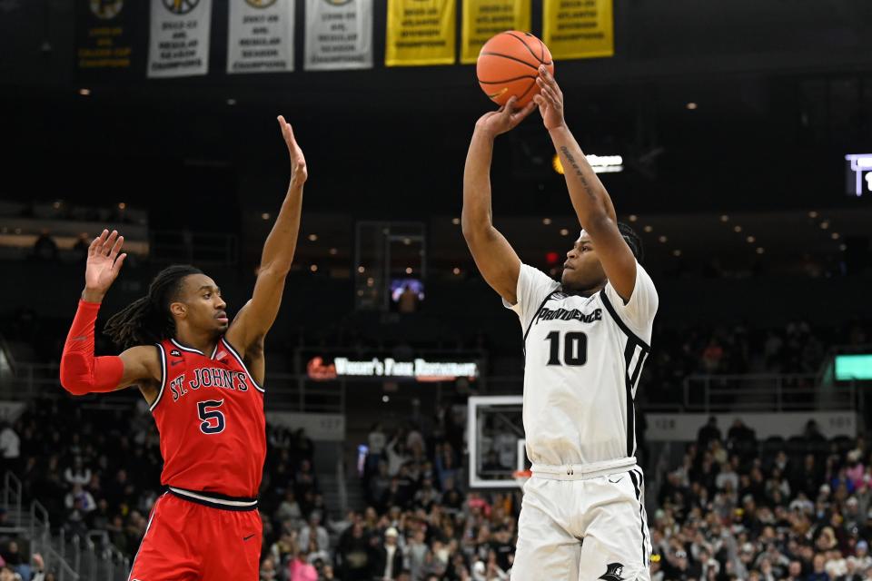 Providence forward Rich Barron shoots over St. John's guard Daniss Jenkins during the first half at Amica Mutual Pavilion.