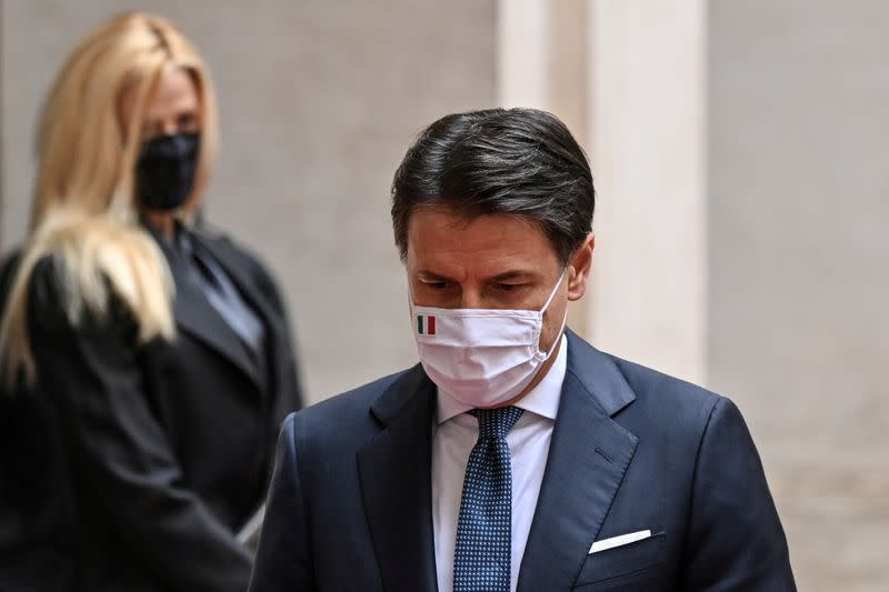 FILE PHOTO: Italy's outgoing Prime Minister, Giuseppe Conte walks past his companion Olivia Paladino as he leaves following a formal handover ceremony with incoming Prime Minister Mario Draghi at Palazzo Chigi in Rome