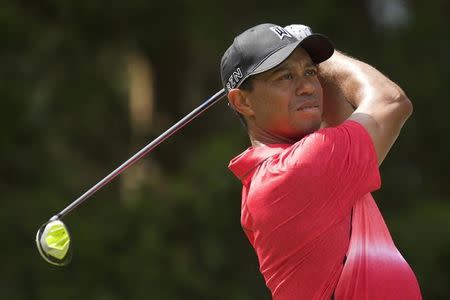 Tiger Woods watches his shot after teeing off on the 2nd hole in the final round of the Quicken Loans National golf tournament at Robert Trent Jones Golf Club. Mandatory Credit: Rafael Suanes-USA TODAY Sports