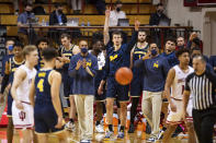 Michigan staff and players react after defeating Indiana in an NCAA college basketball game, Saturday, Feb. 27, 2021, in Bloomington, Ind. (AP Photo/Doug McSchooler)