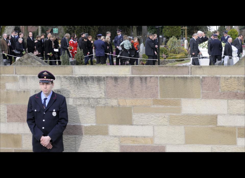 A 17-year-old gunman dressed in combat gear kills nine students and three teachers at a school near Stuttgart. He also kills one other person at a nearby clinic. He was later killed in a shoot-out with police. Two additional passers-by were killed and two policemen seriously injured, bringing the death toll to 16, including the gunman.<br>  <em>Caption: The coffin with the remains of a victim of the school shooting is carried on the cemetery in Winnenden, near Stuttgart, Germany, on Saturday, March 14, 2009. (AP Photo/Daniel Maurer</em>