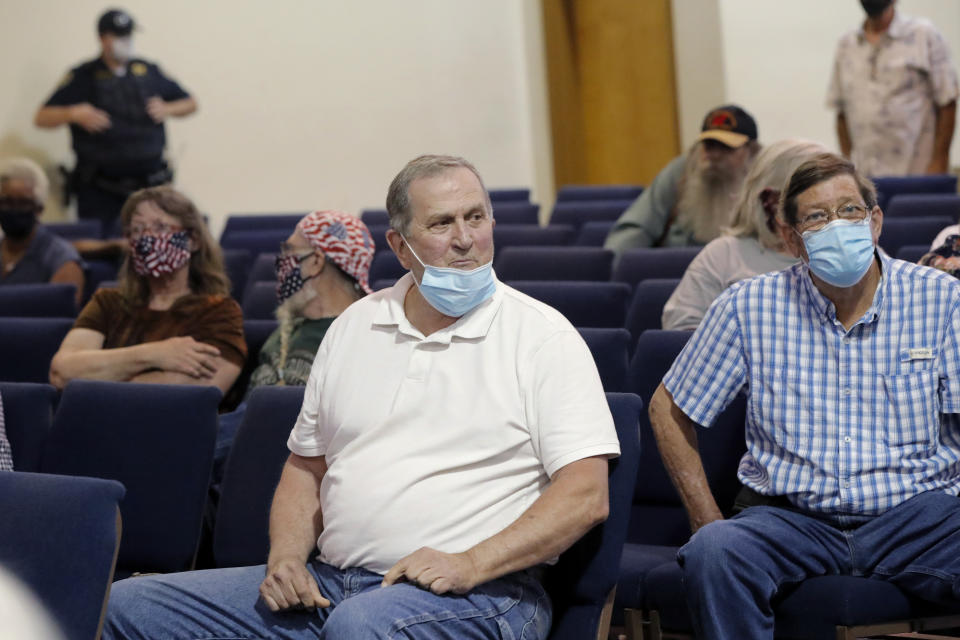 Jim Hirtzler, center, listens to speakers that want a statue of a Confederate soldier in front of the East Feliciana Parish courthouse to be removed, at a town hall meeting to discuss its fate, in Clinton, La., on June 30, 2020. As protests sparked by the death of George Floyd in Minneapolis focus attention on the hundreds of Confederate statues still standing across the Southern landscape, officials in the rural parish of roughly 20,000 people recently voted to leave the statue where it is. (AP Photo/Gerald Herbert)